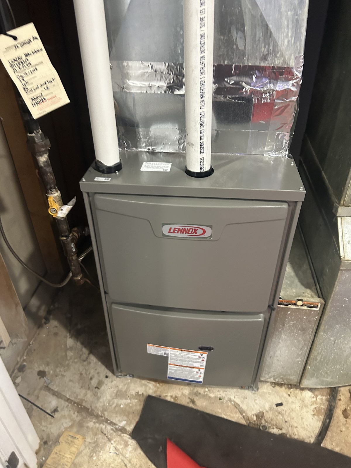 High-efficiency Lennox furnace installed with certified gas line connection and PVC venting