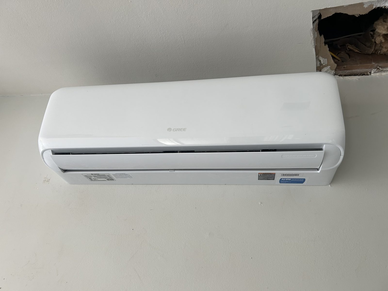 GREE ductless mini-split indoor unit mounted high on an interior wall